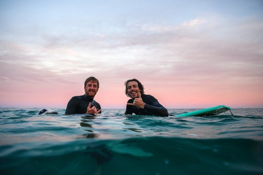 Two friends having fun surfing
